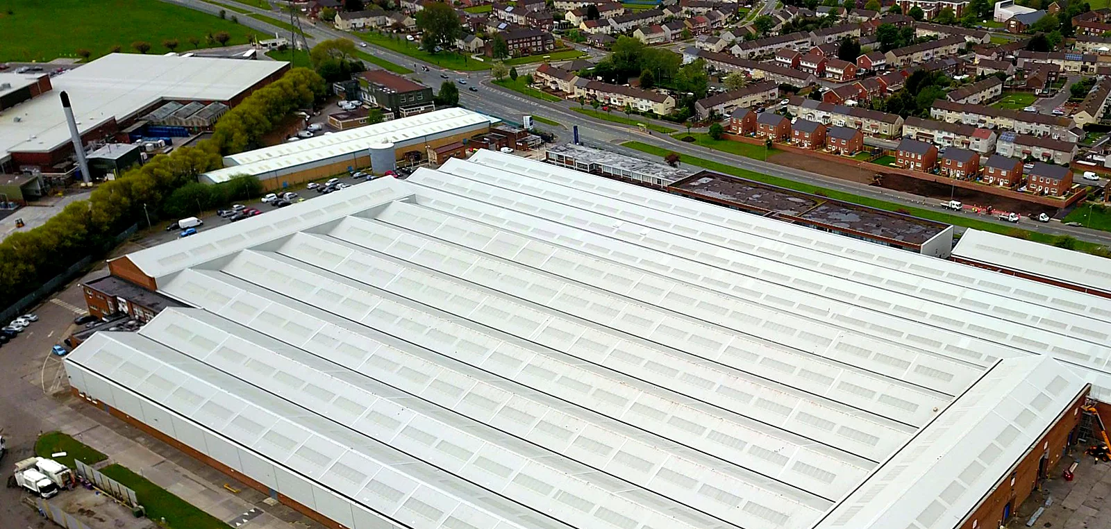 Aerial view of a large multi-bay factory roof