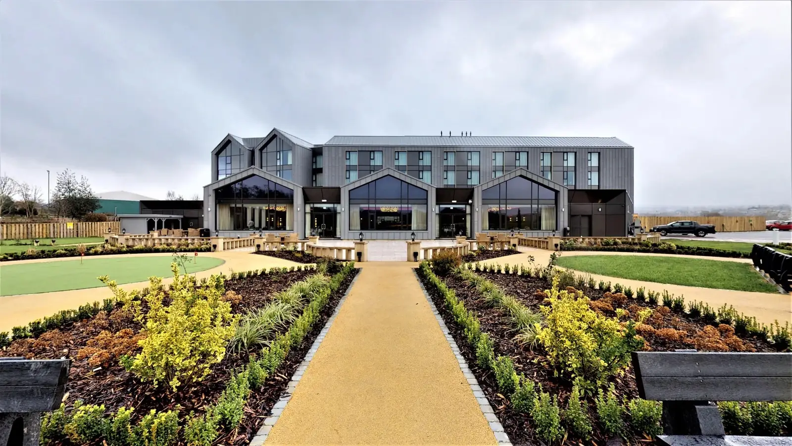 Crow Wood hotel and spa building seen across formal landscaped gardens with a central path