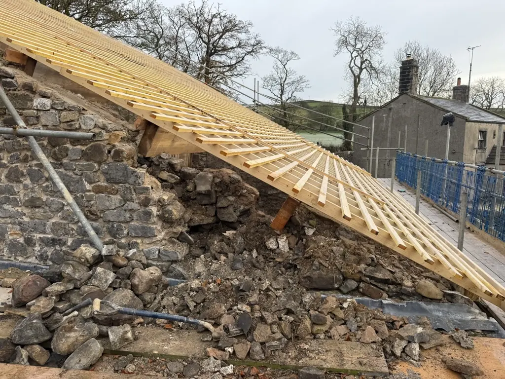 Exposed wall head of the barn with new timber battens fixed over the roof slope