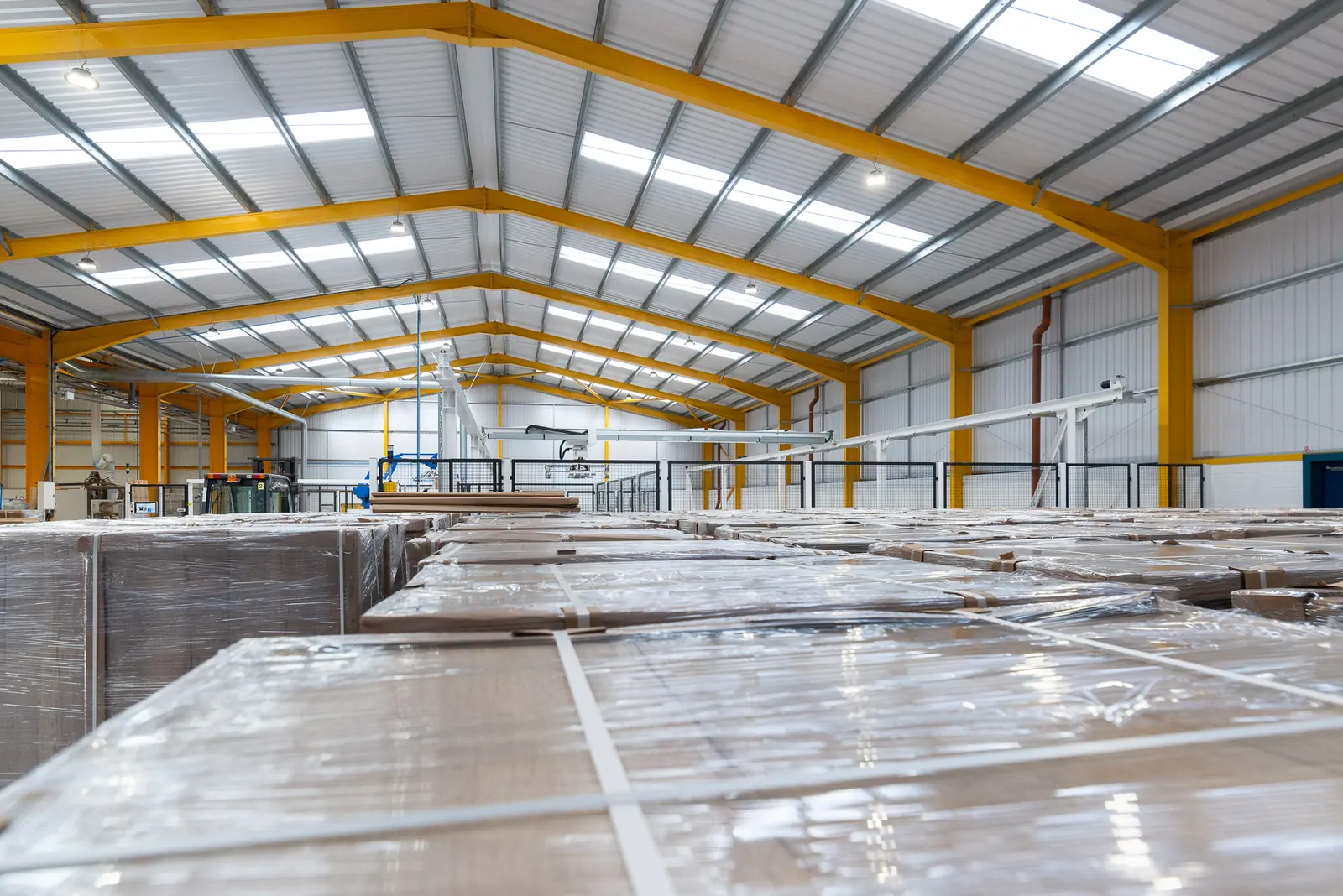 Wrapped panel stock stacked inside the high bay Watson factory building