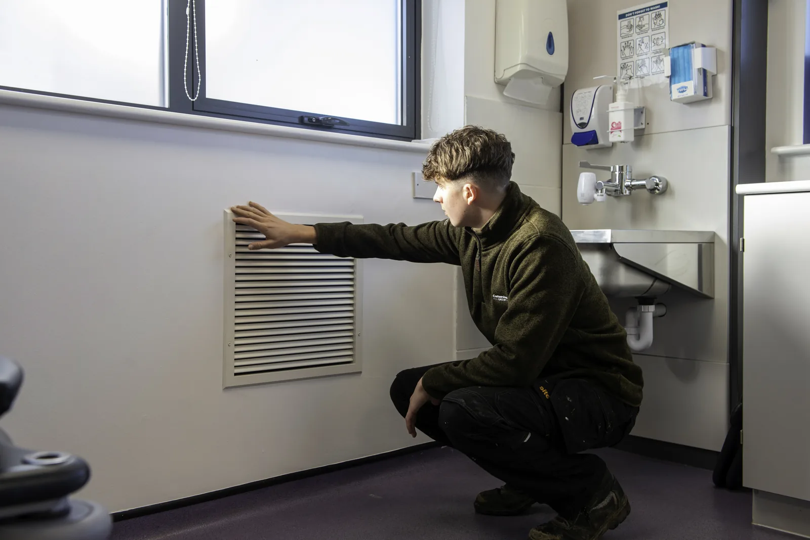 Cornerstone engineer checking a ventilation grille in a new clinical room