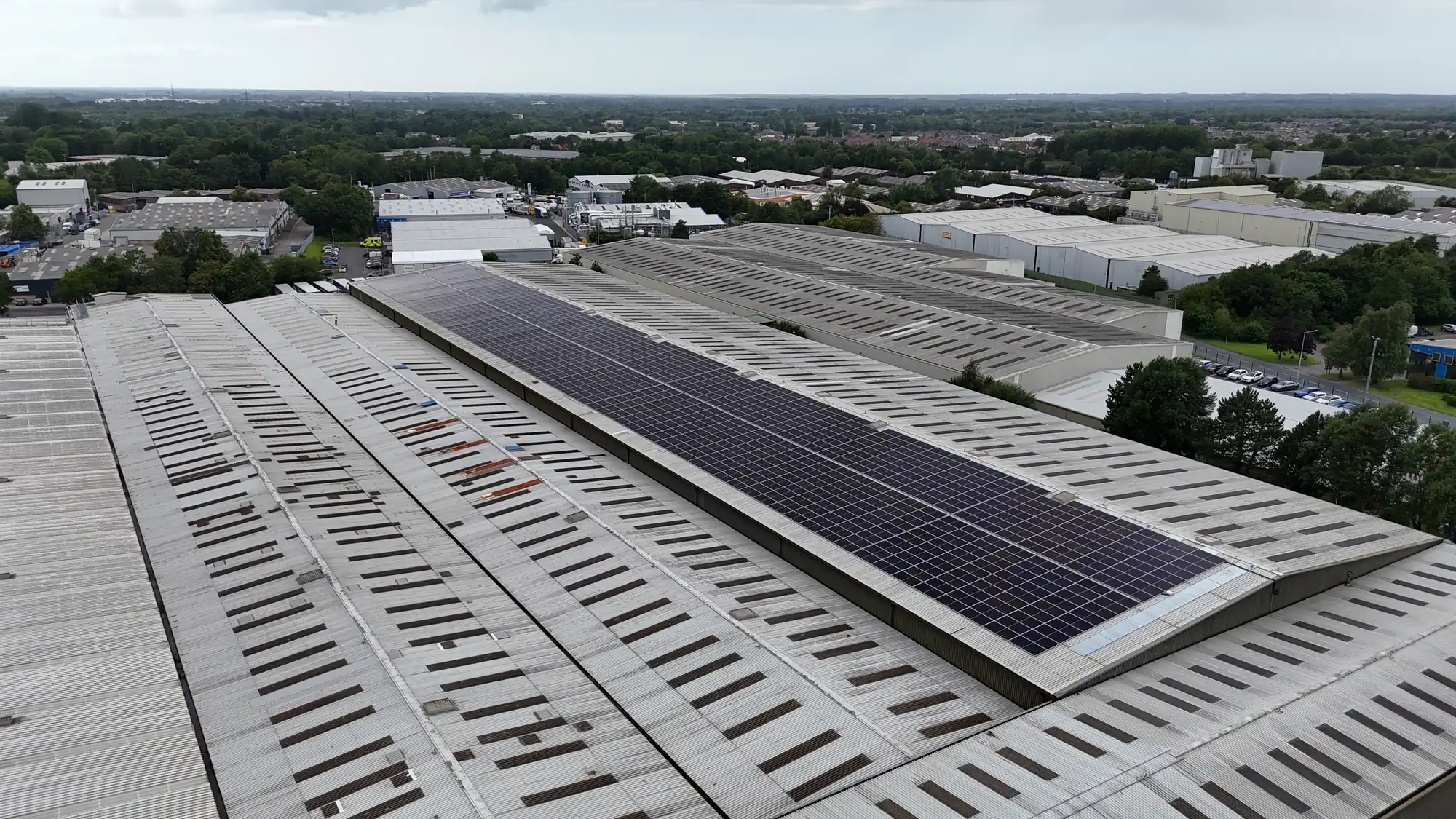 Drone view of solar panels on the FDC warehouse roof with the surrounding industrial estate