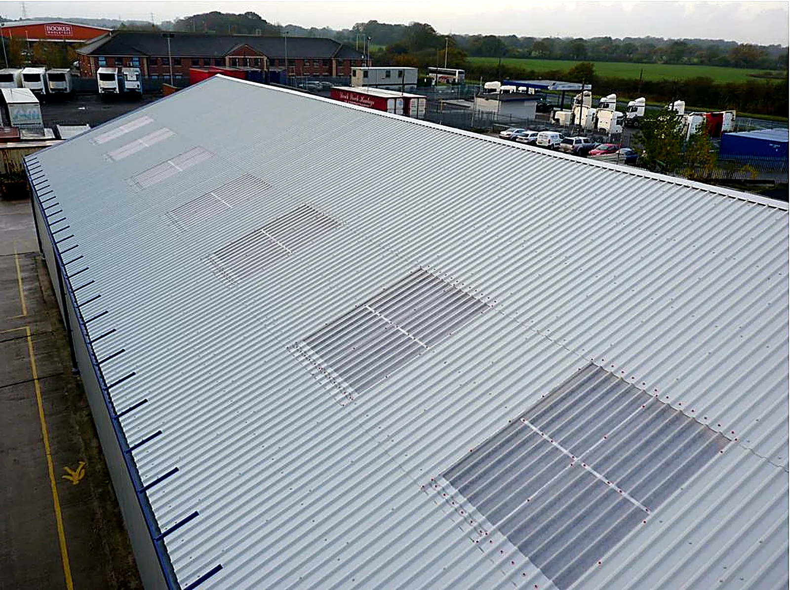 New twin-skin metal roof with rooflight panels on an engineering works