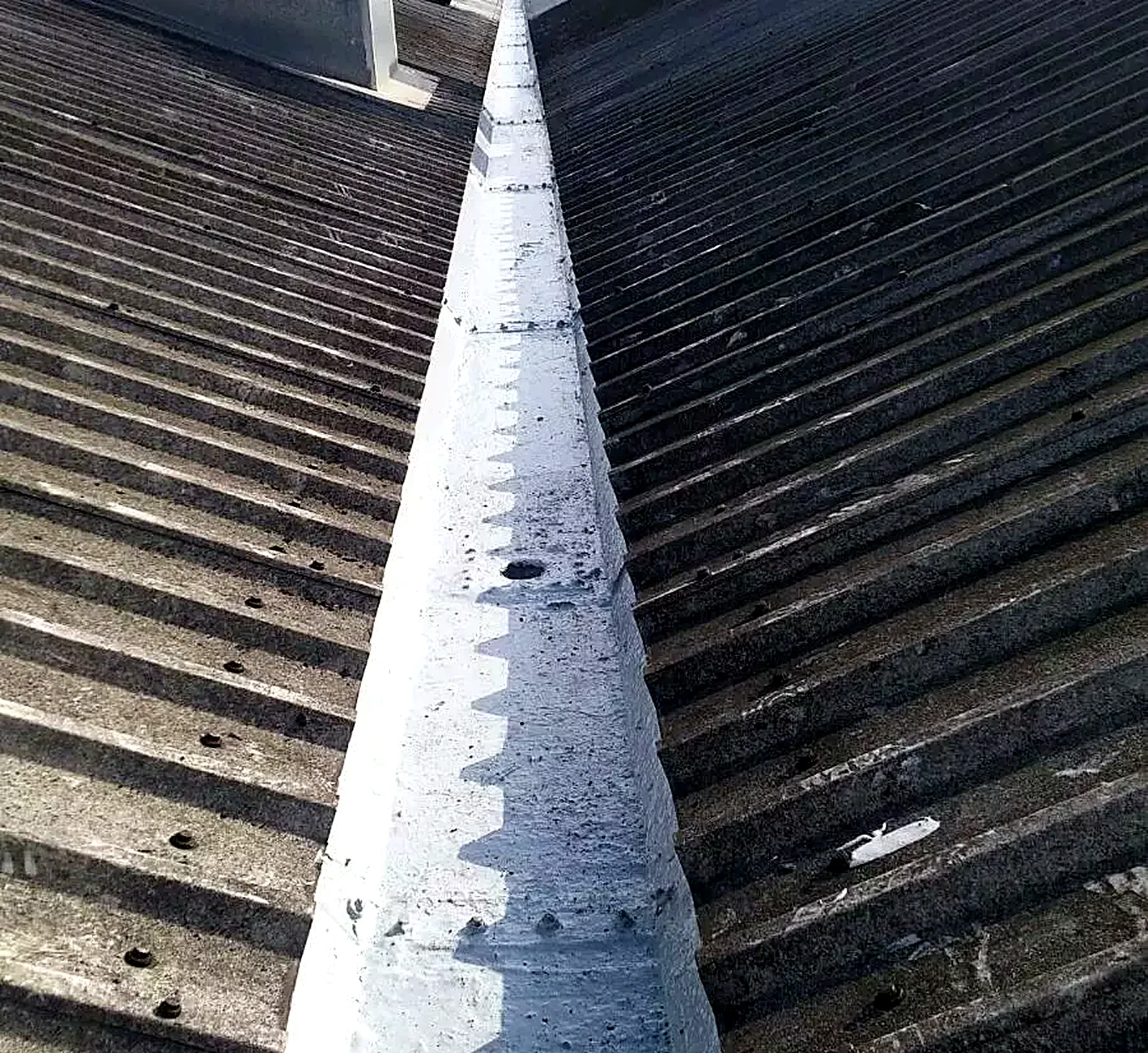Gutter lining applied along an industrial roof valley
