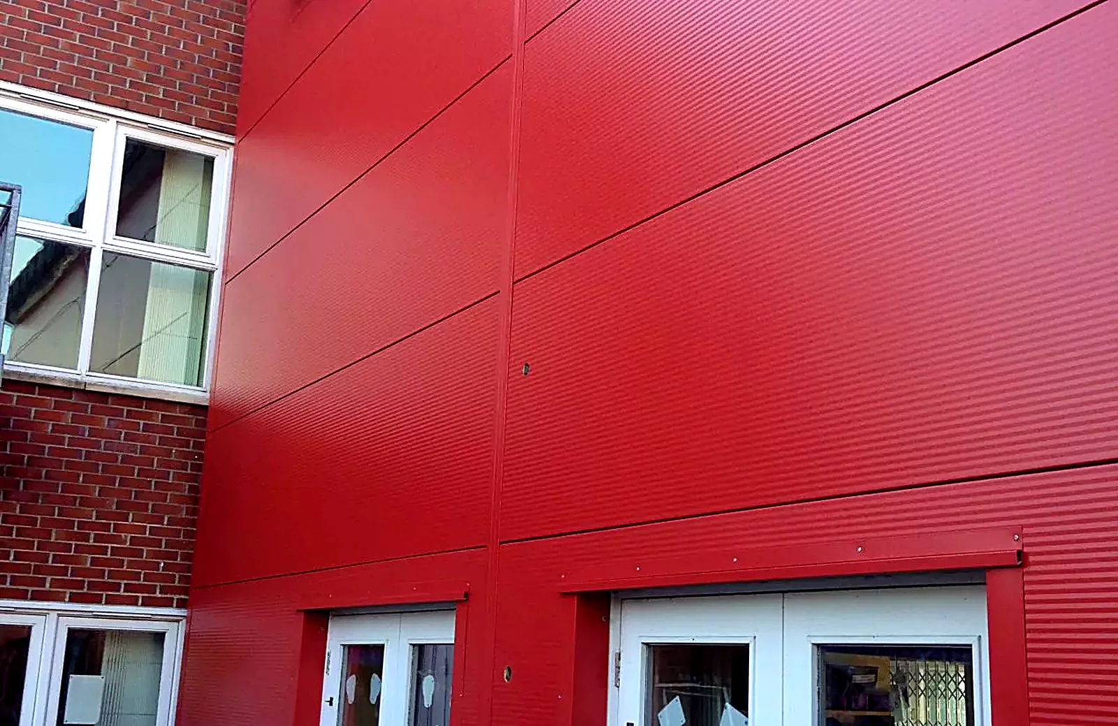 New red profiled wall cladding on a commercial building