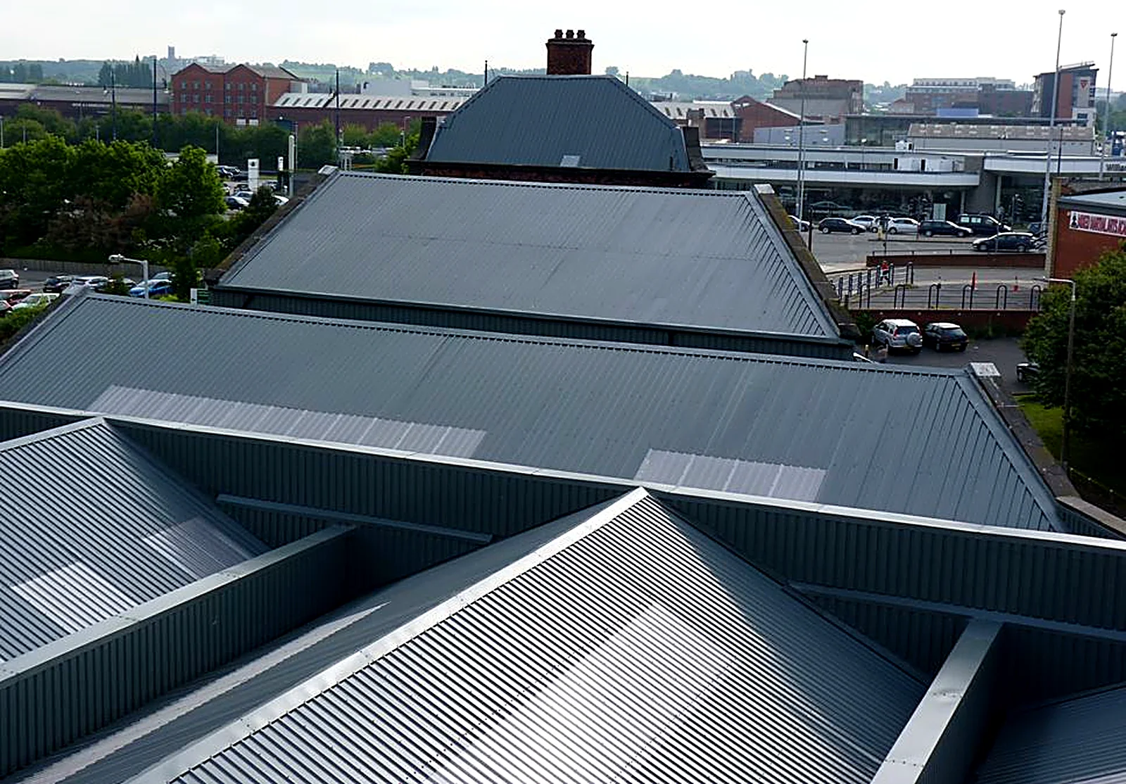 New grey metal roofs across a former mill complex