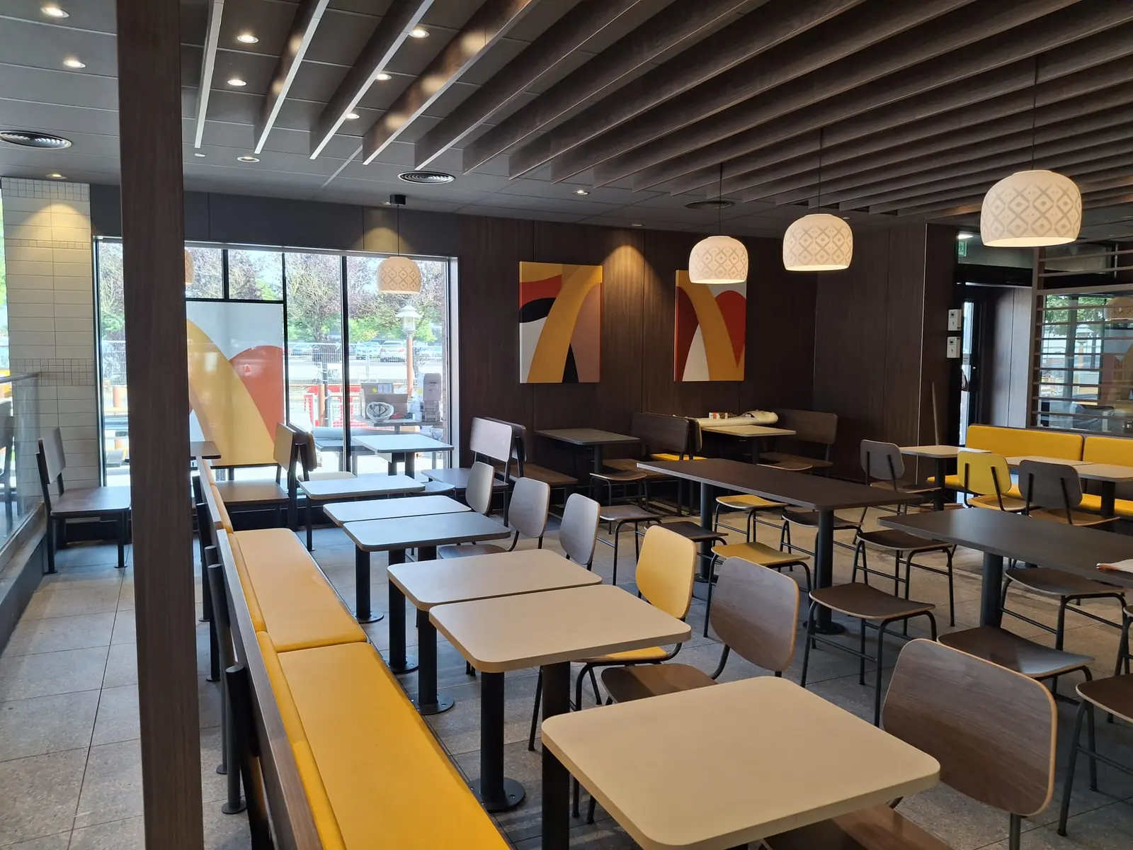 Refurbished seating area with slatted timber ceiling and pendant lights