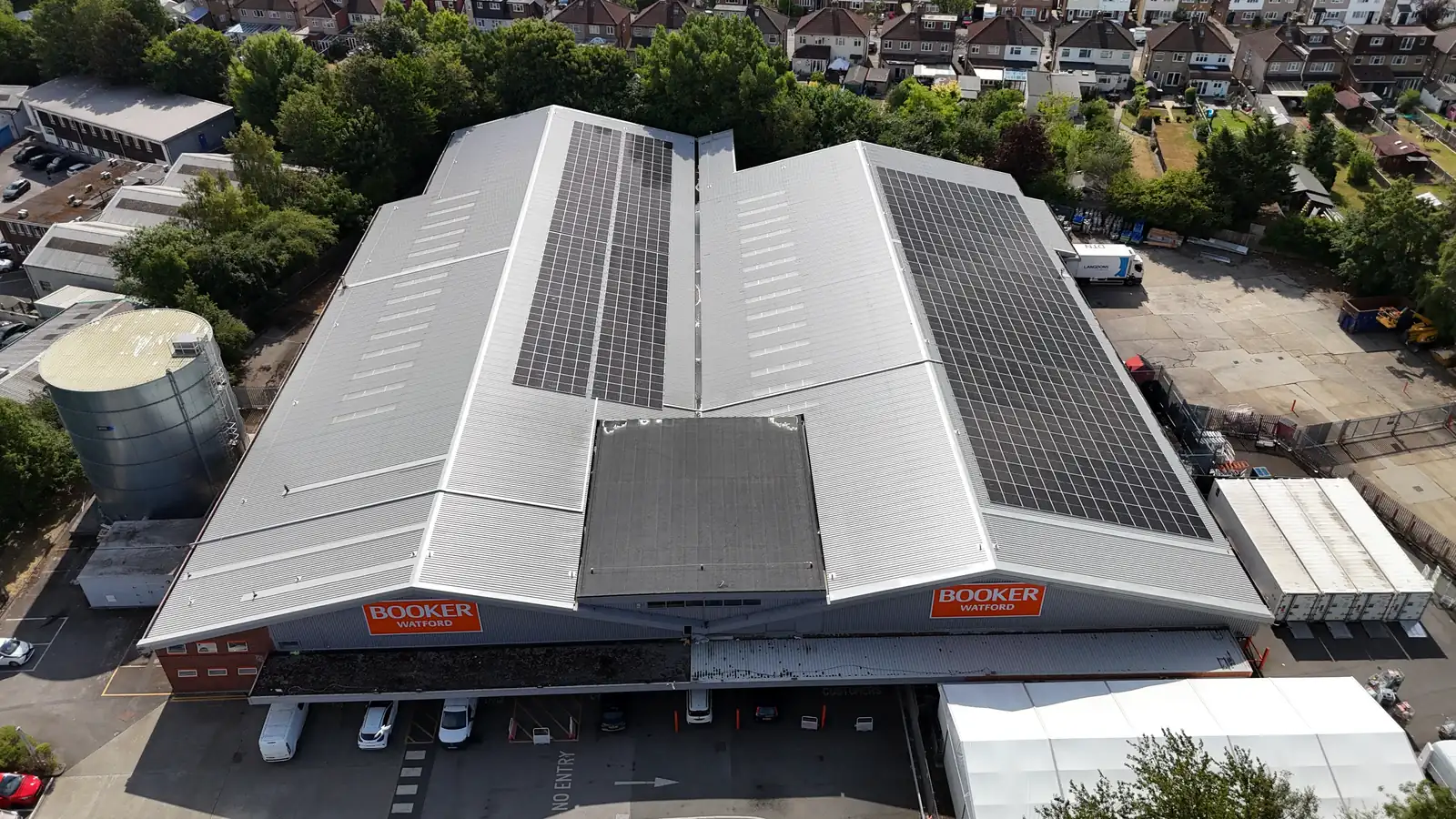 Front aerial of Booker Watford with solar on both roof pitches
