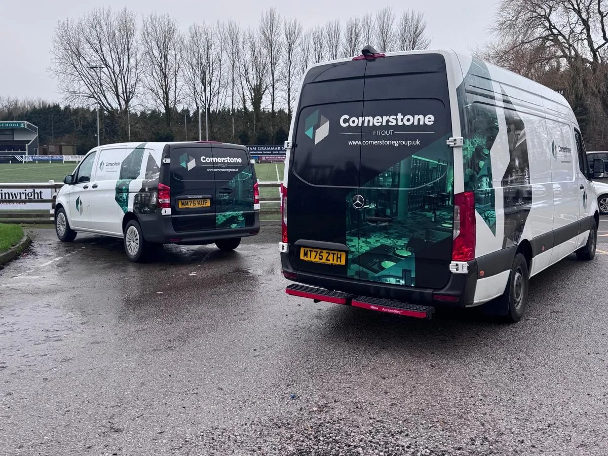 Cornerstone vans beside the pitch at Preston Grasshoppers