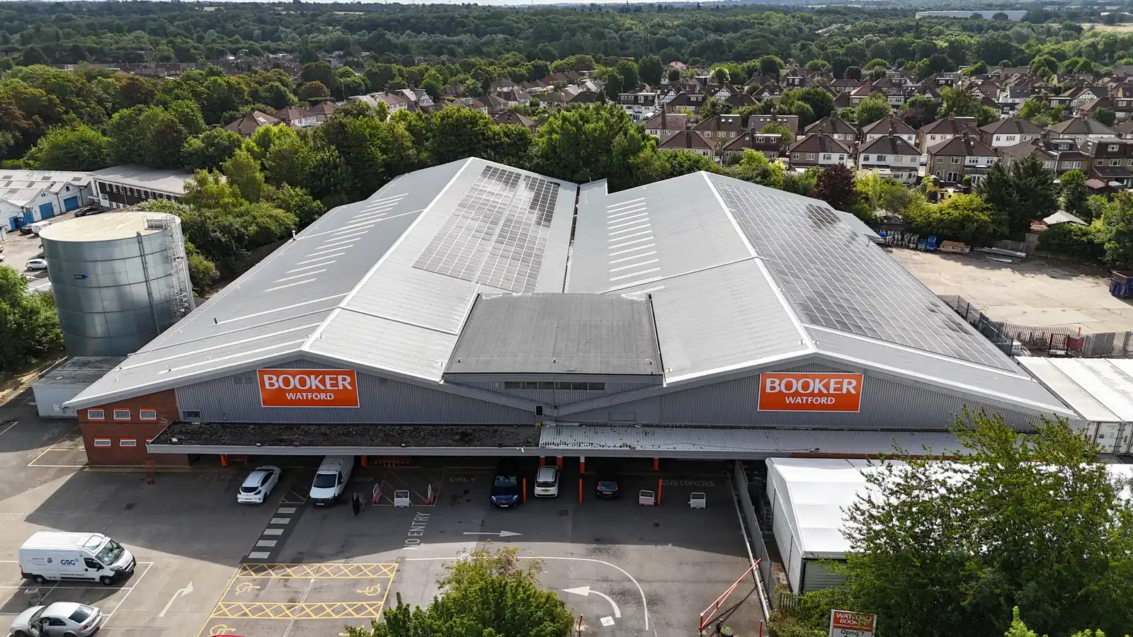 Booker Watford warehouse elevation with the new roof and solar seen from the car park side